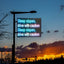 Electronic sign warning of steep slopes with a sunset in the background