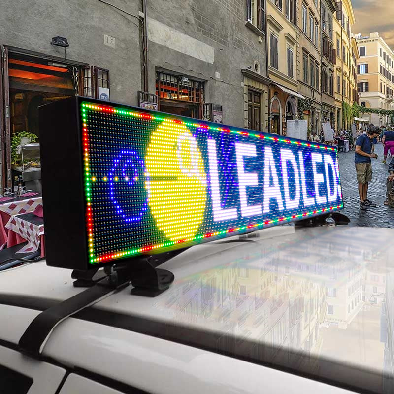 LED sign on a car roof with colorful display in an urban setting
