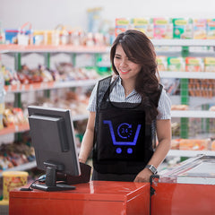 Woman working at a grocery store checkout counter with shelves in the background