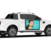 White pickup truck with a digital display showing a woman's face and 'ALISA' branding.