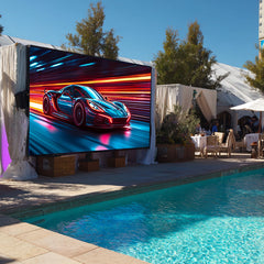 Outdoor setting with a large screen displaying a car graphic near a pool.