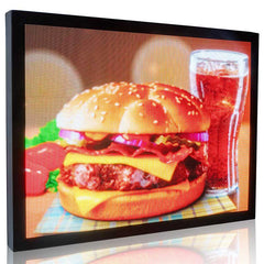 Digital display showing a burger and a glass of juice on a checkered tablecloth.