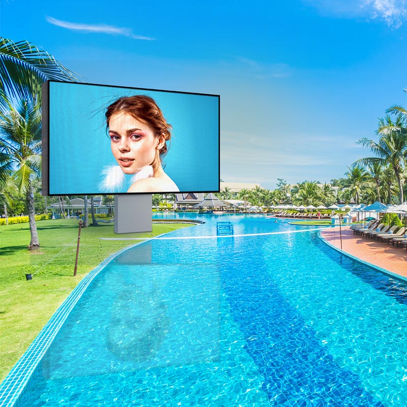 Large outdoor screen displaying a woman's face with a pool and palm trees in the background
