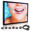 Digital display screen with a dental examination image and a cable on a white background