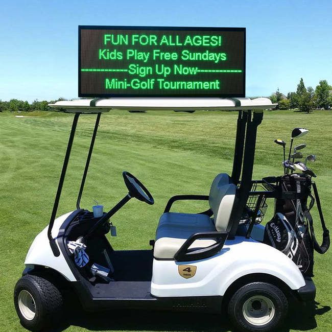 Golf cart with a digital sign on a golf course advertising a mini-golf tournament. Main image