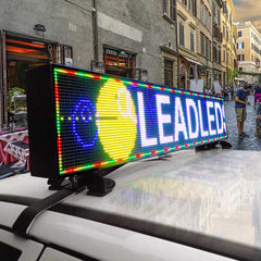 LED sign on a car roof with colorful display in an urban setting
