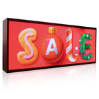 LED sign with 'SALE' and Christmas-themed decorations on a red background