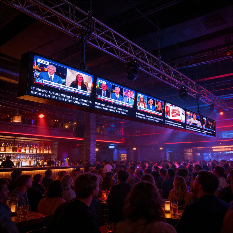 People watching a sports event on multiple screens in a bar.