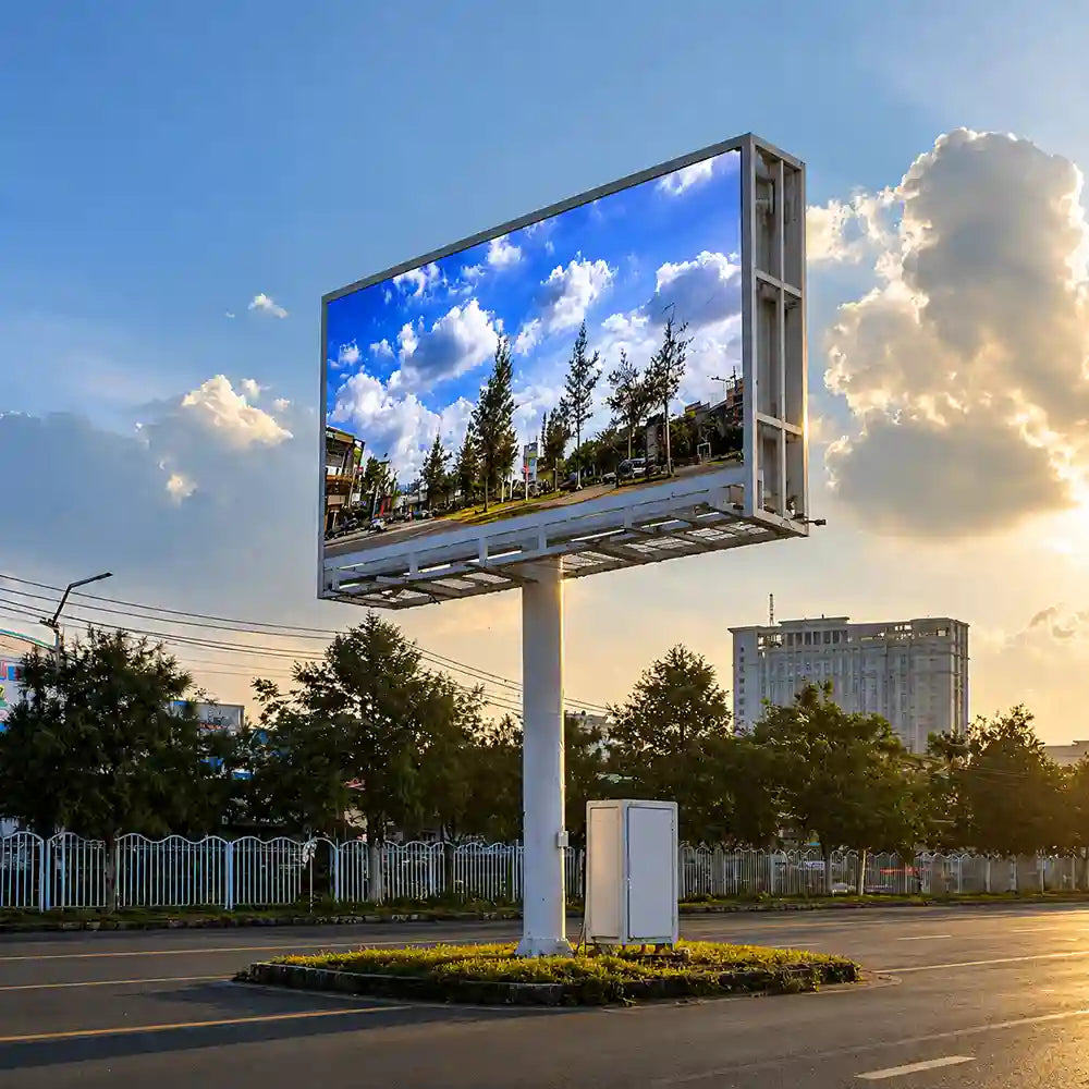 Digital billboard displaying a scenic view of trees and buildings with a blue sky