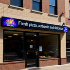 Pizza restaurant with a sign advertising fresh pizza, authentic, and delicious.