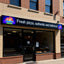 Pizza restaurant with a sign advertising fresh pizza, authentic, and delicious.