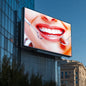 Billboard displaying a dental-themed advertisement on a building facade.