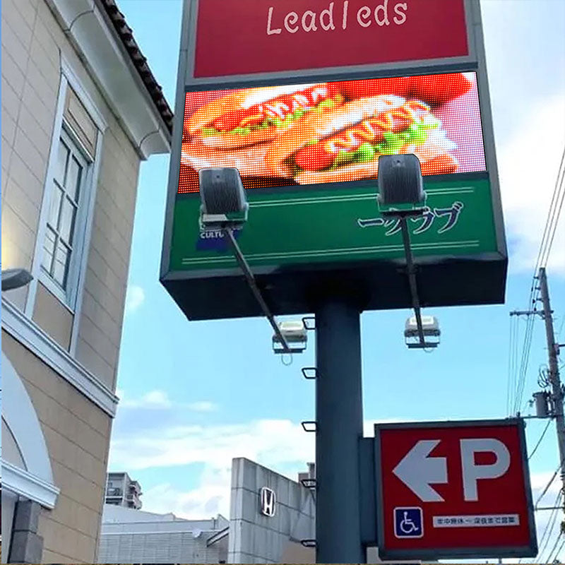 Digital billboard displaying a hotdog graphic with a clear blue sky in the background