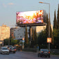 LED Billboard displaying a scenic image of flowers on a city street with cars and buildings